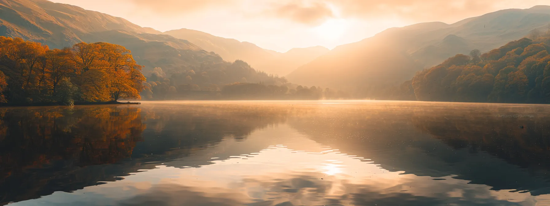 a breathtaking golden sunrise casts an ethereal glow over a serene lake, mirrored perfectly in the still water, surrounded by majestic mountains and vibrant autumn foliage.