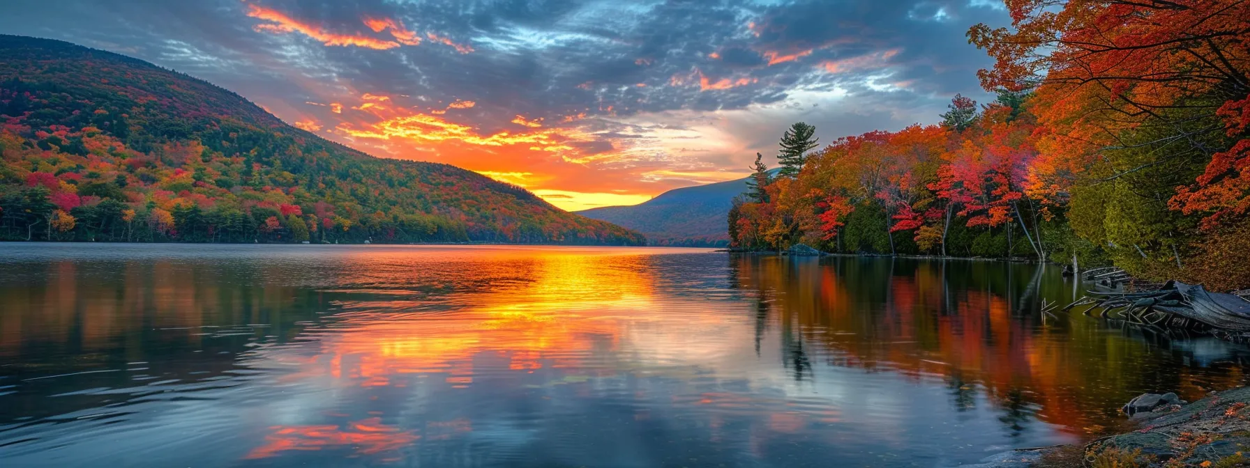 a breathtaking sunset casts a warm golden glow over a serene lake, with vibrant autumn foliage reflecting on the tranquil water's surface.
