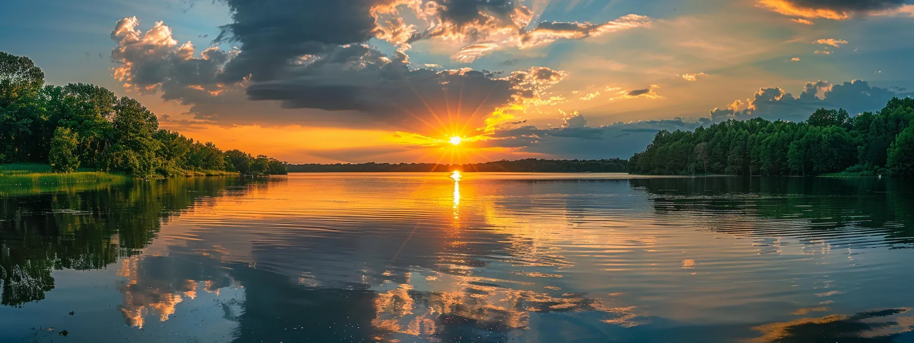 a breathtaking sunset casts golden hues over a serene lake, reflecting the vibrant colors of the sky while surrounded by lush, emerald green forests.