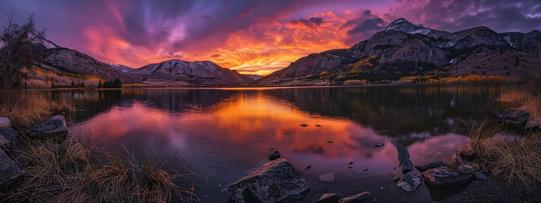 a breathtaking sunset paints the sky in vibrant hues of orange and purple, casting a warm glow over a serene lake, where the tranquil water perfectly reflects the colorful spectacle above.