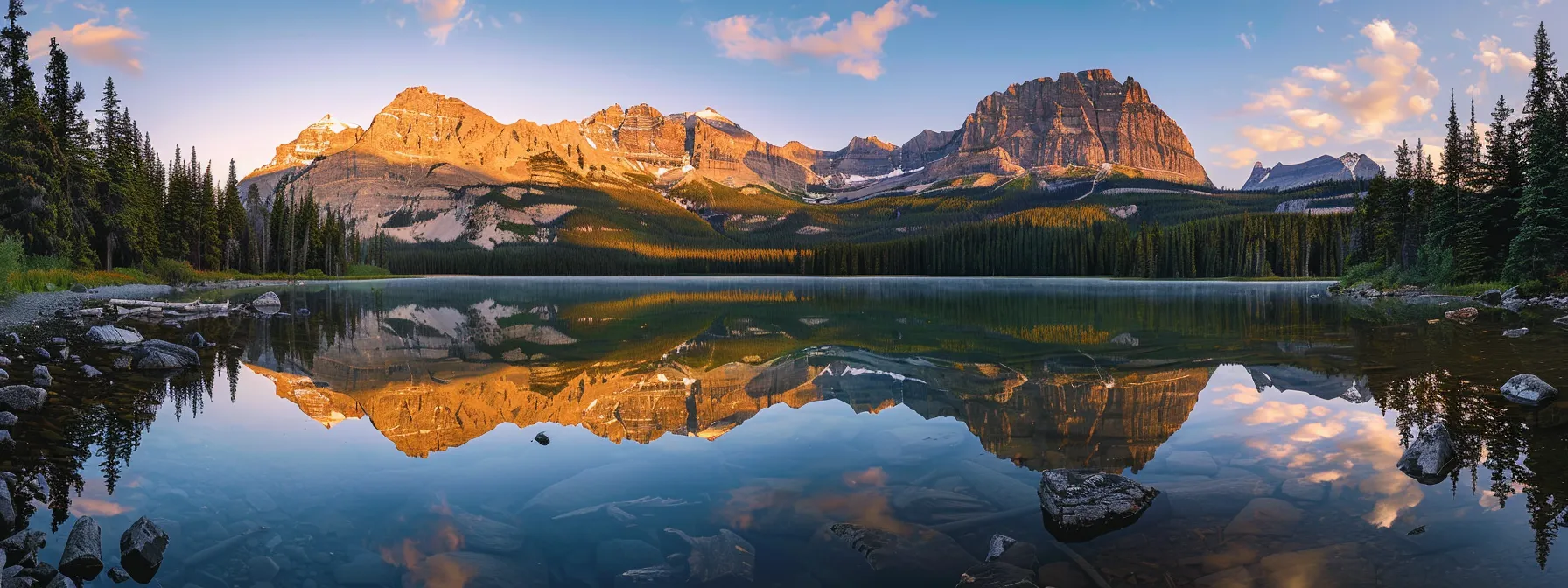 a majestic mountain landscape bathed in golden sunrise light, with towering peaks reflected in a serene, crystal-clear lake.