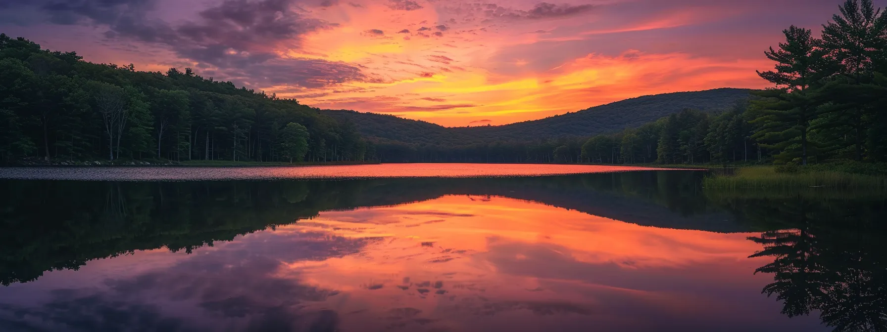 a mesmerizing sunset casts vibrant hues of orange and pink across a serene lake, reflecting the tranquil beauty of nature and evoking a sense of peaceful solitude.