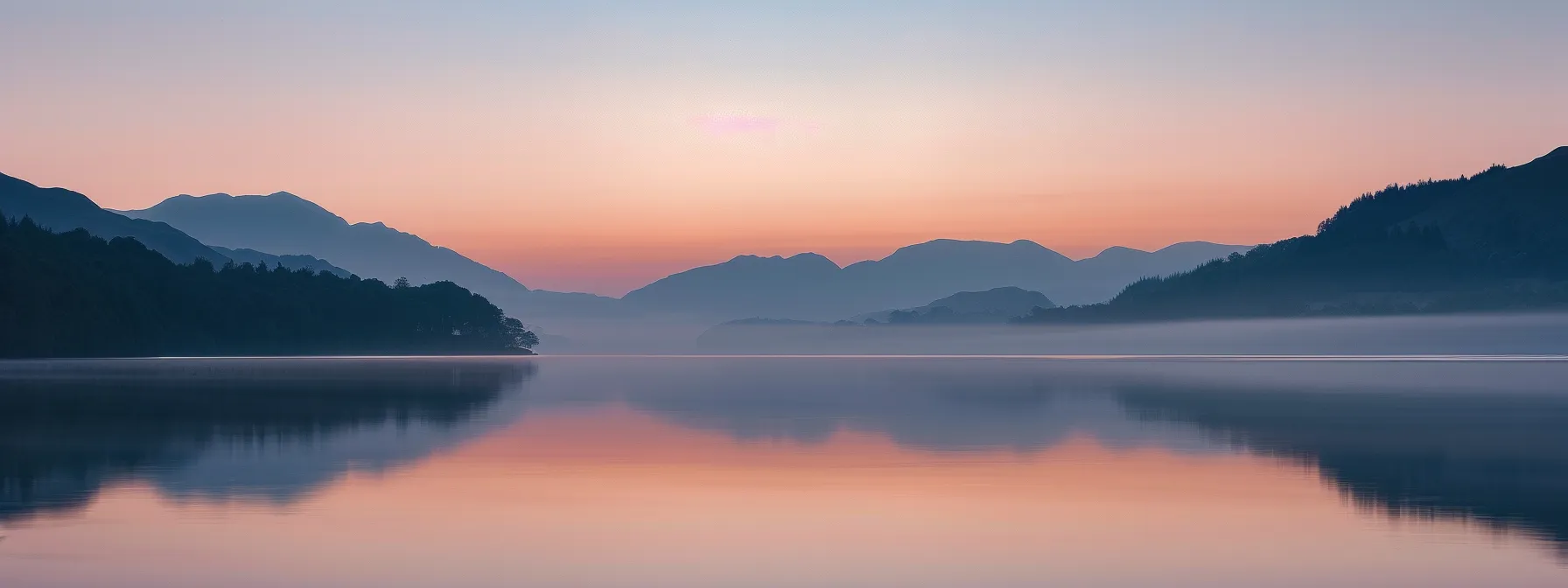 a serene landscape unfolds at dawn, showcasing a tranquil lake reflecting vibrant hues of orange and pink, framed by misty mountains under a clear sky.