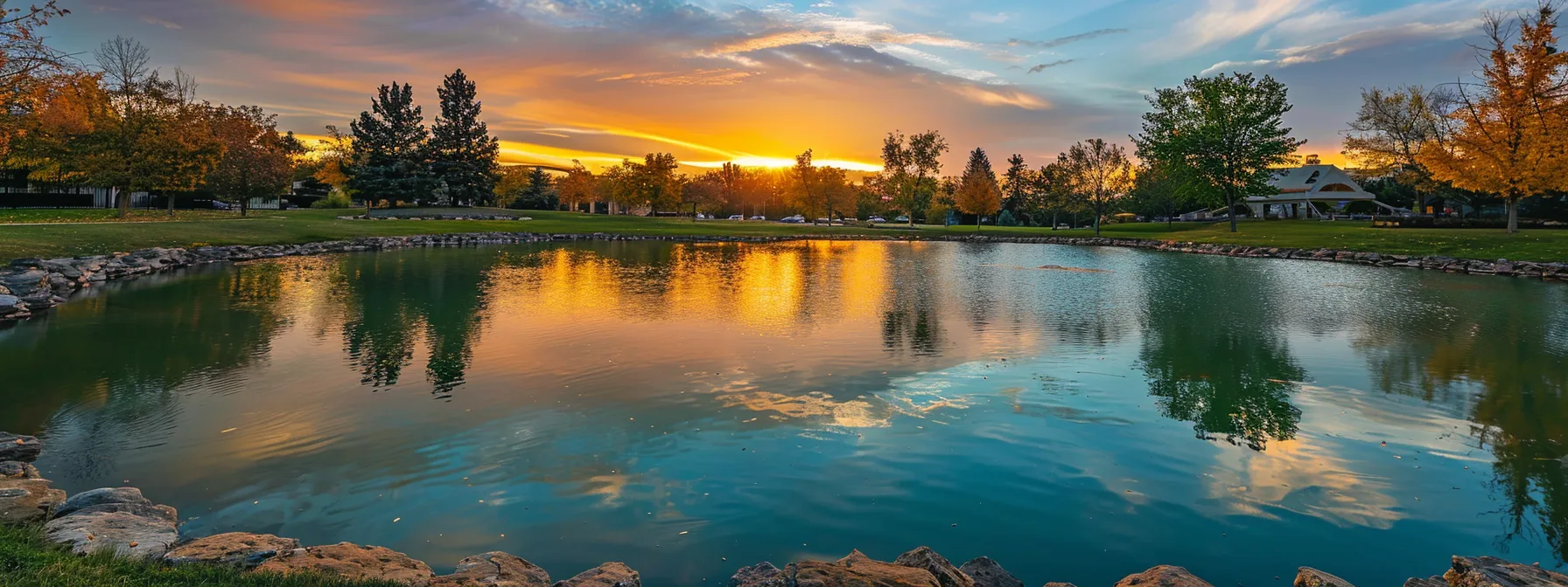 a vibrant sunset casts a warm golden glow over a tranquil lake, reflecting the fiery hues of the sky and creating a serene atmosphere that invites calm and contemplation.