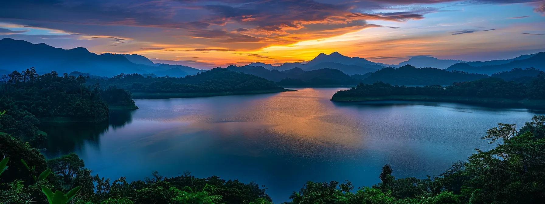 a vibrant sunset casts a warm glow over a tranquil lake, surrounded by lush greenery and silhouetted mountains, evoking a sense of peace and natural beauty.