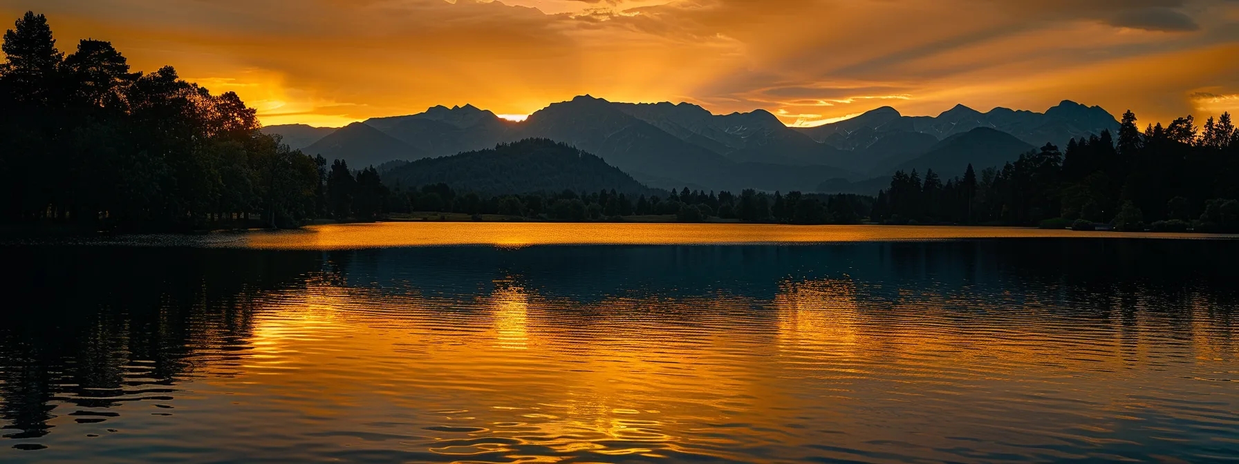 a vibrant sunset casts a warm golden glow over a tranquil lake, reflecting the silhouette of distant mountains and the delicate outlines of lush trees along the shore.
