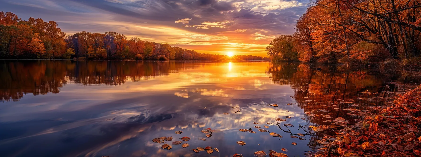 a vibrant sunset casts a golden glow over a tranquil lake, where the rich colors of autumn leaves reflect in the still water, creating a serene and breathtaking atmosphere.