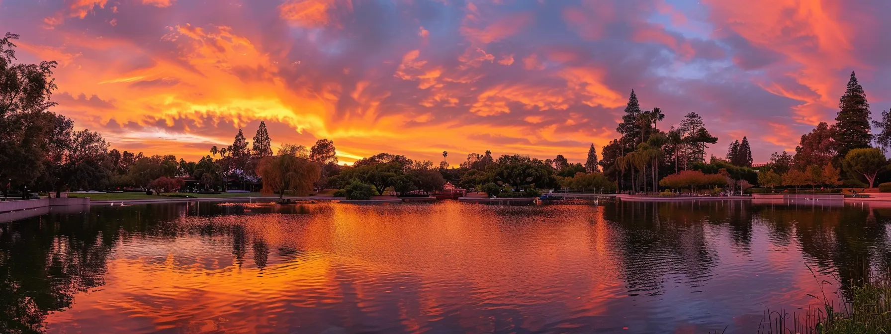 a vibrant sunset paints the sky in brilliant hues of orange and pink, casting a warm glow over a tranquil lake reflecting the breathtaking spectacle.