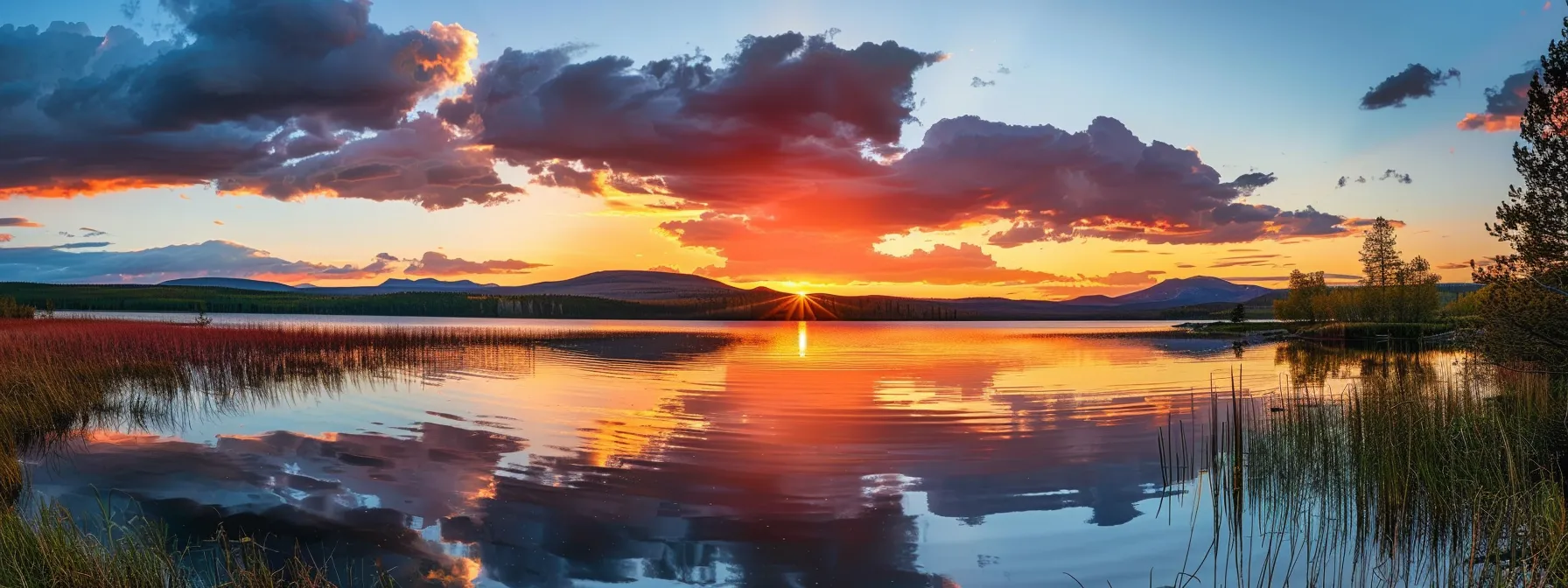 a vibrant sunset casts brilliant hues of orange and pink across a serene lake, reflecting the tranquil beauty of nature for a captivating composition.